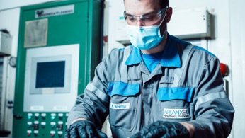 Man working next to green machine