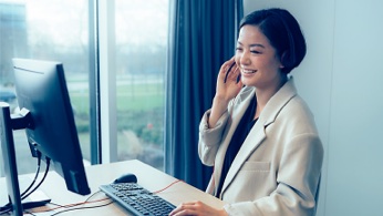 Women behind computer calling